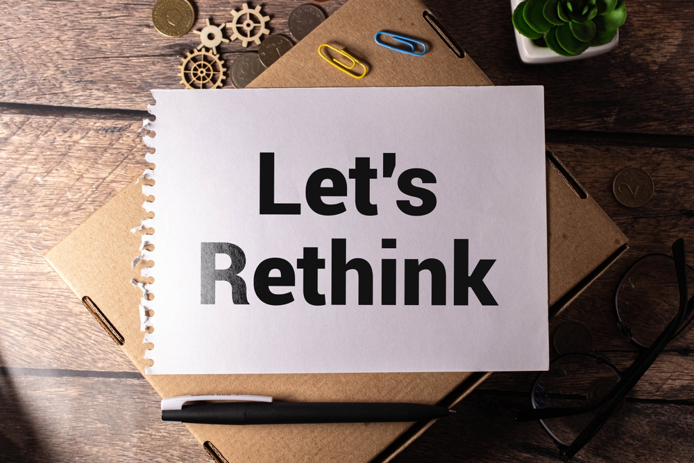 Decorative image of a sheet of paper with text that says Let's Rethink