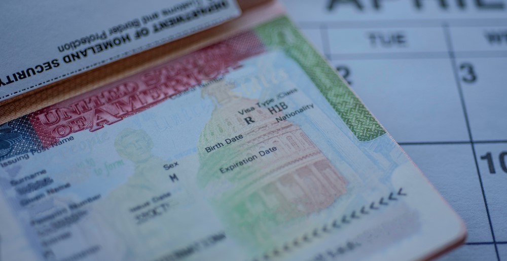 Image of an H-1B Visa and a calendar.